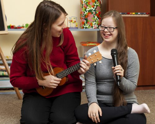 woman-with-guitar-girl-with-down-syndrome-having-fun